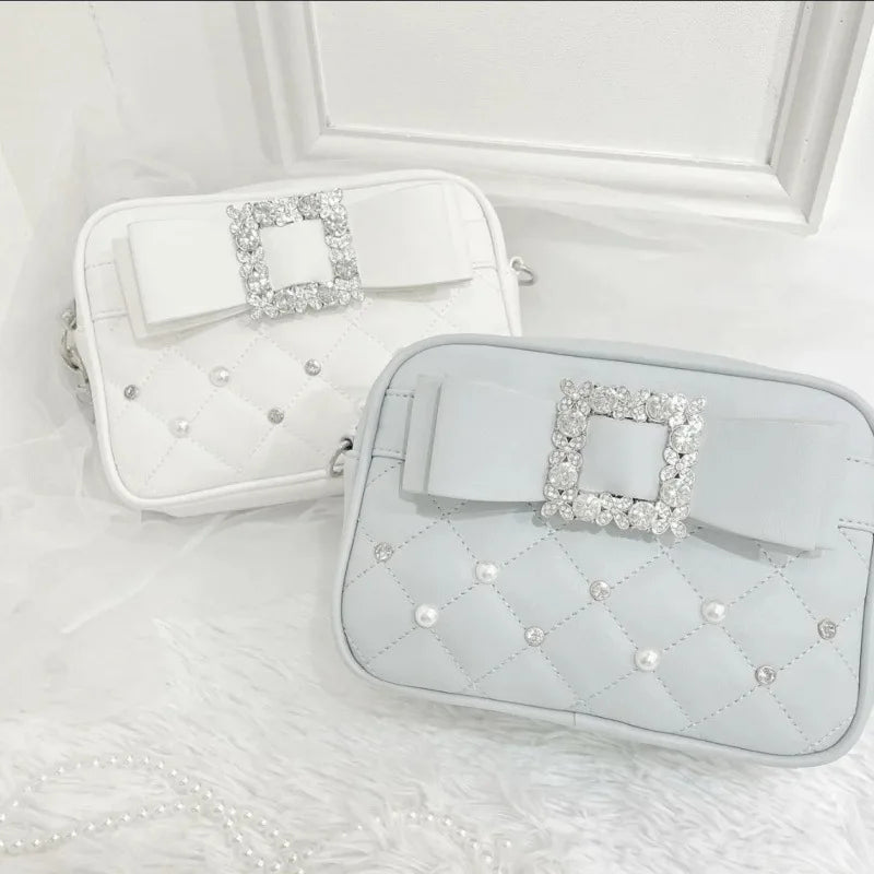 Cream and powder blue quilted crossbody bags shown together
